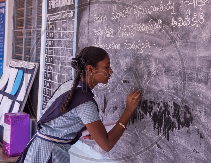 Student at Govt School writing on Black Board