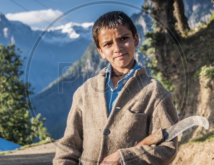Kid with working tool in Kwar Village, Himachal Pradesh