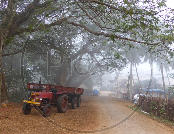 Tractor parked near Tree