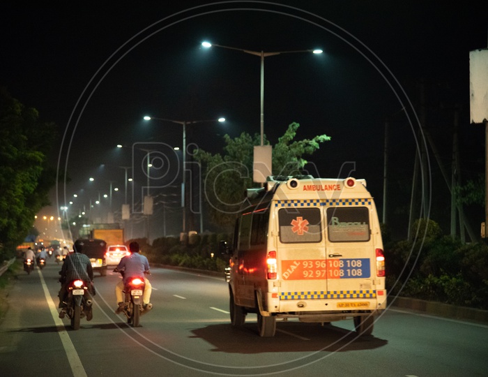 An Ambulance at Night under LED Street Lamps/Lights