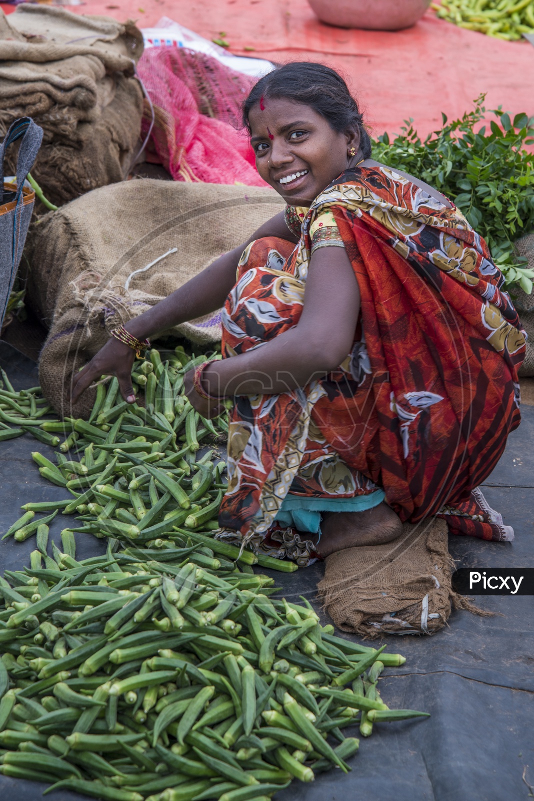 Happy Female Vegetable Vendor at Gudimalkapur Flower Market