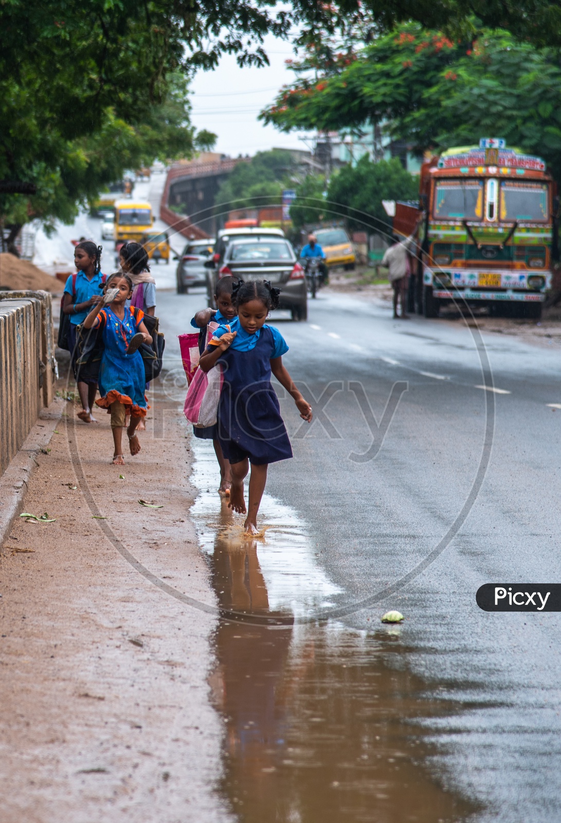government school students/girls playing in monsoon