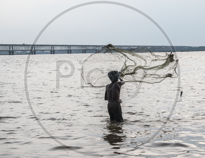 Fisherman tossing his net