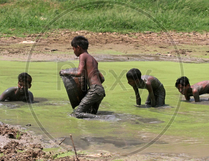 Image of Kids in a dried pond-NX667599-Picxy