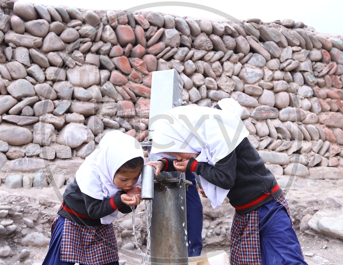 School Kids Drinking Water using Hand Pump