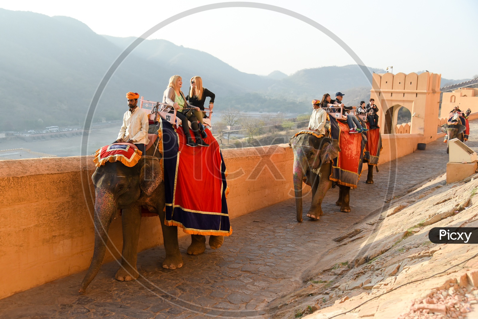 Tourists Enjoying ride atop Elephants