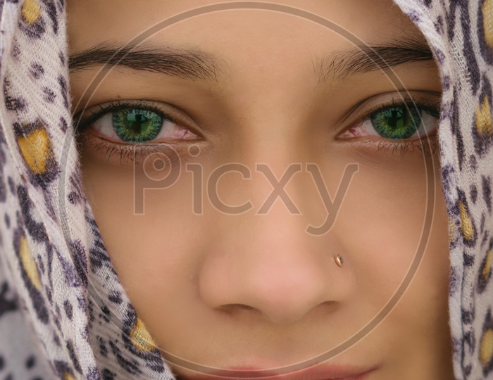 close up of  girl  wearing green contact lens
