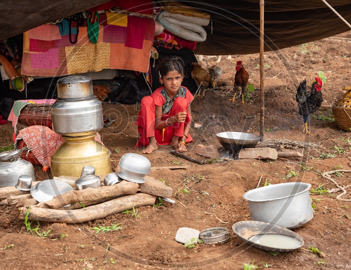A little girl of a shepherd family cooks meal for her parents
