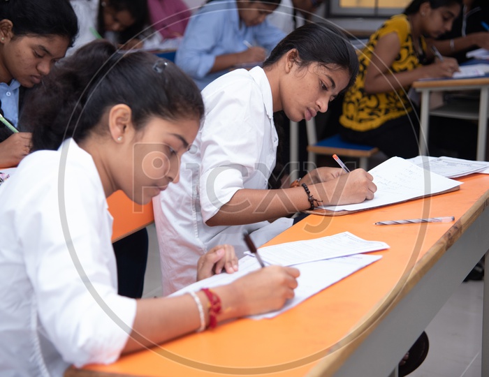 Girl students writing exam at an educational institute.
