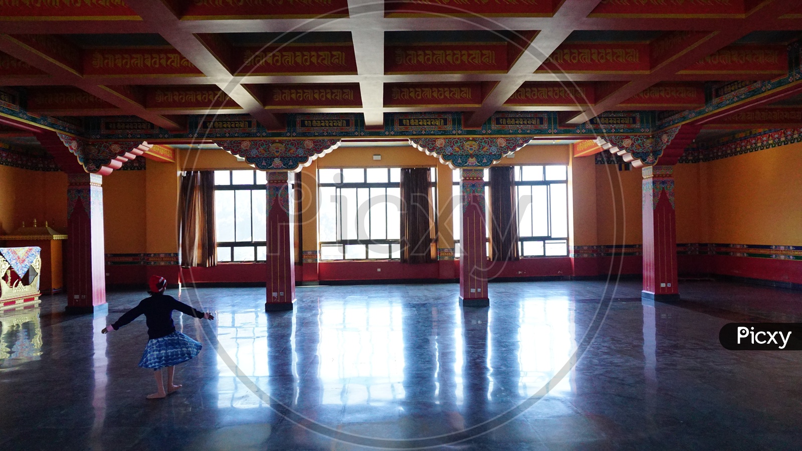 Dancing girl in silence and beauty of Lava Monastery hall