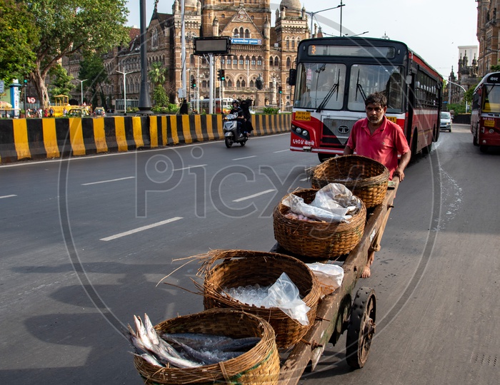 Fisherman carries his cart on busy Mumbai CST Circle