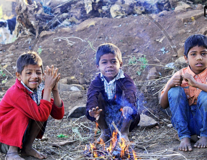 Sweet kids shaking themselves in winter with fire