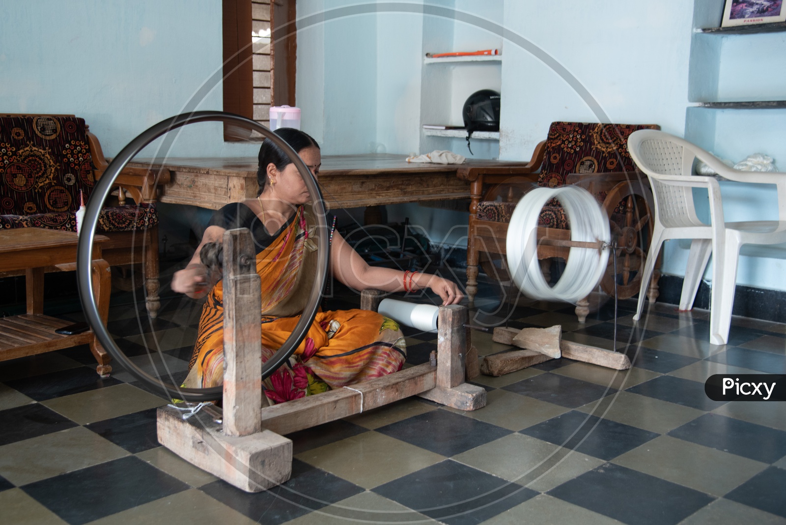 Making thread for weaving on Spinning wheel (Charkha)