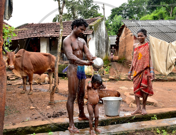Tribal Father bathing his child in Araku Valley