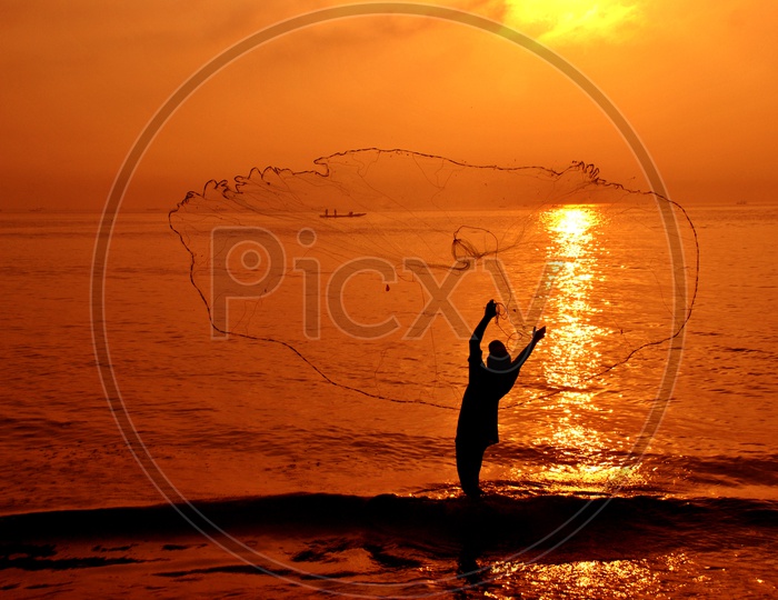 Fishermen throwing Fishing Net