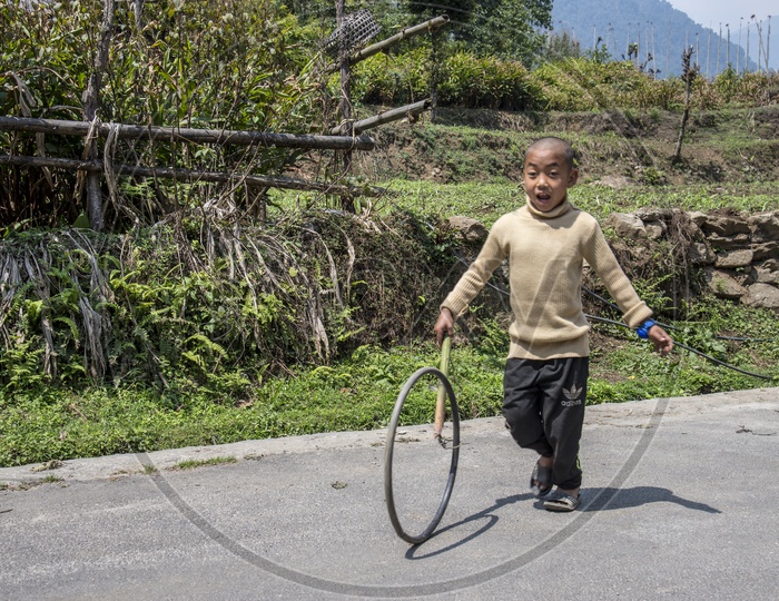 Kid Playing with Tyre in Yuksom, Sikkim