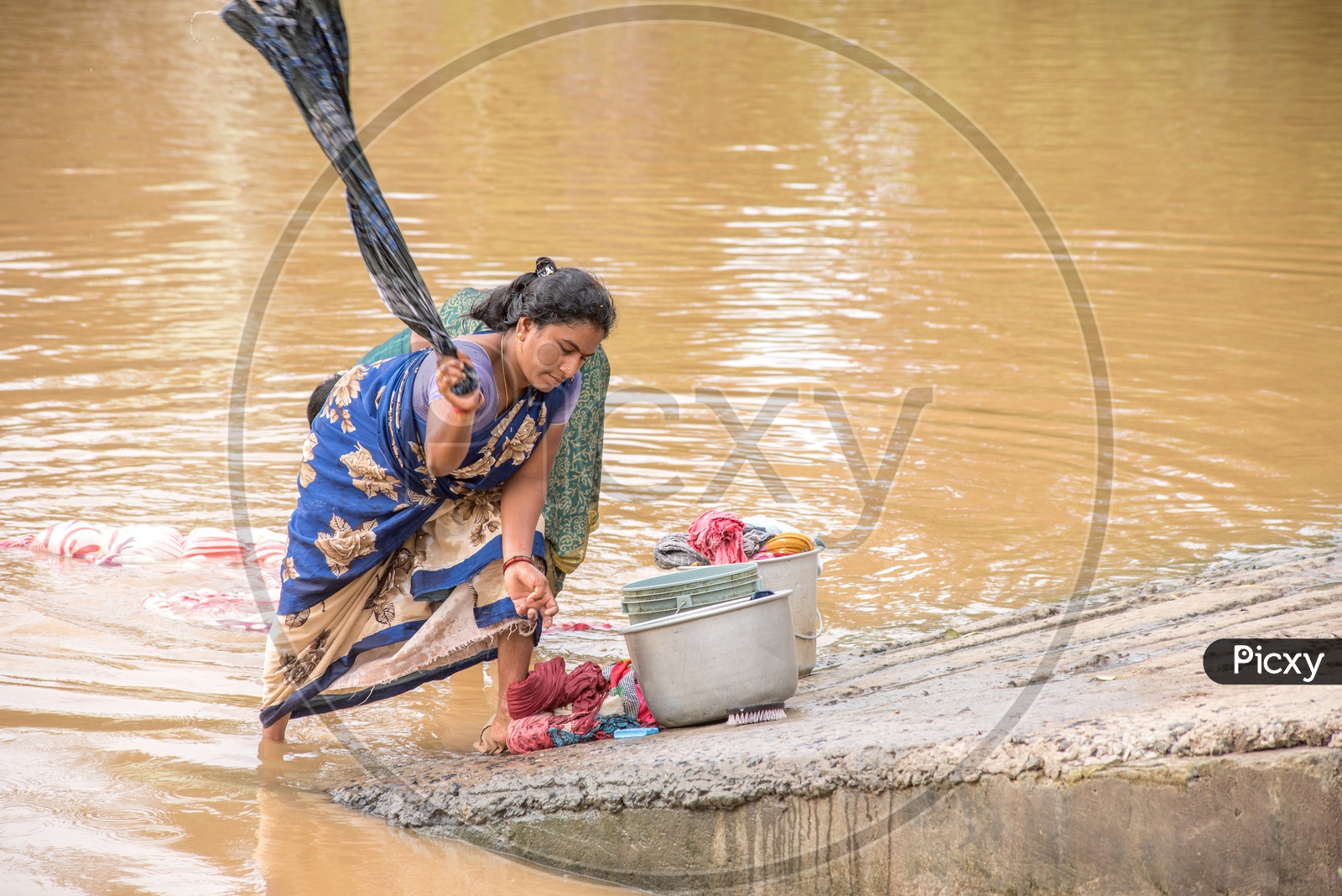 villagers using river water for washing clothes