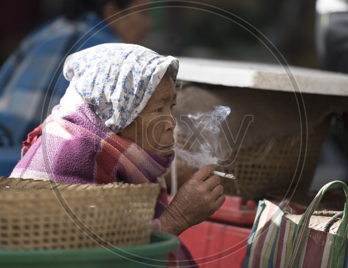 Woman Smoking at Ema Market, Manipur
