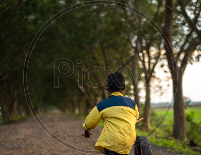 A kid Playing on a road between Chiluvuru and Namburu