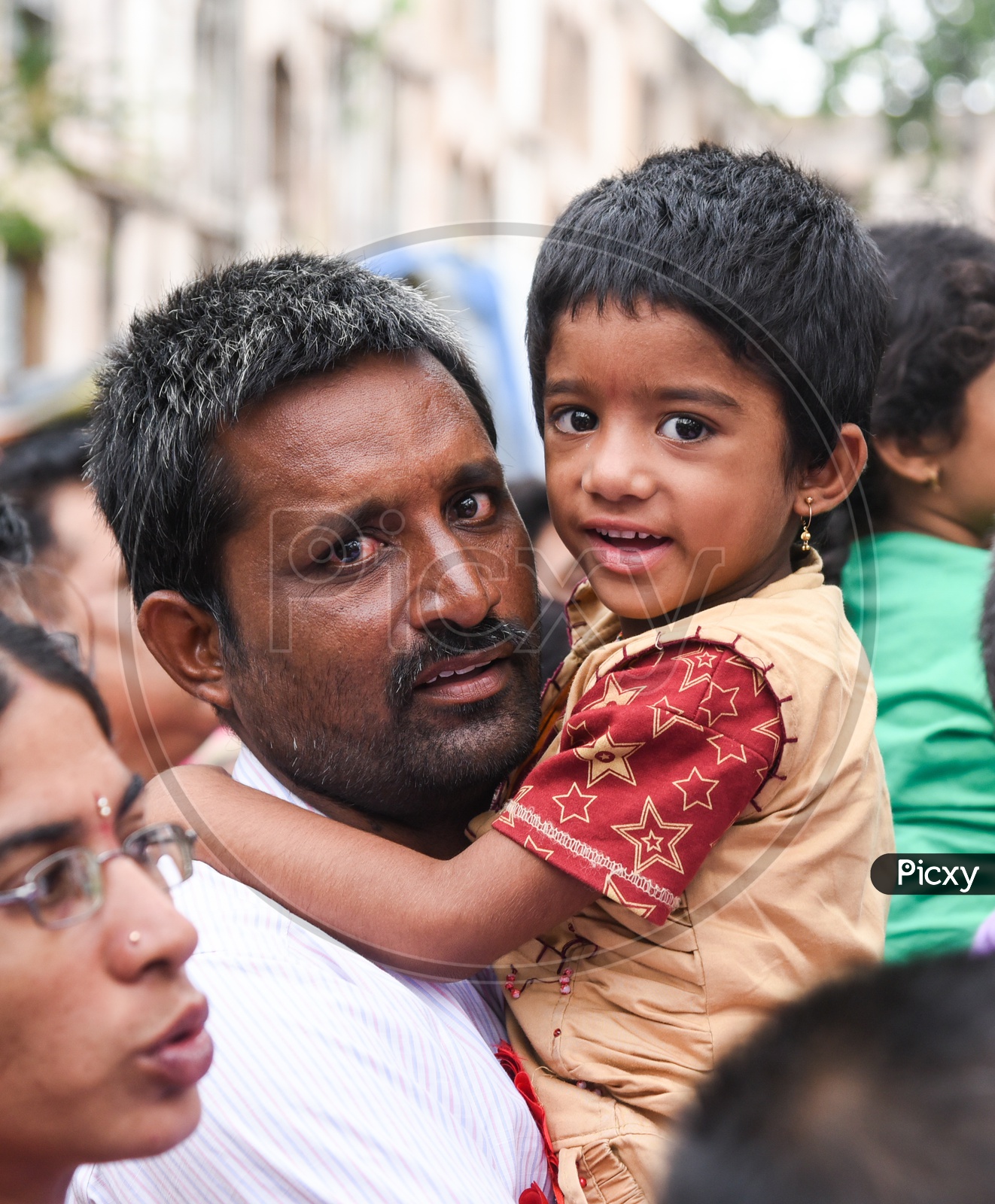 Man & Daughter in a queue for Fish Prasadam for Ashthma Cure