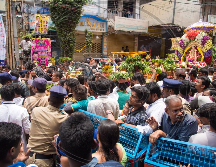 Police controlling the crowd visiting Mahankali Bonalu at Secunderabad