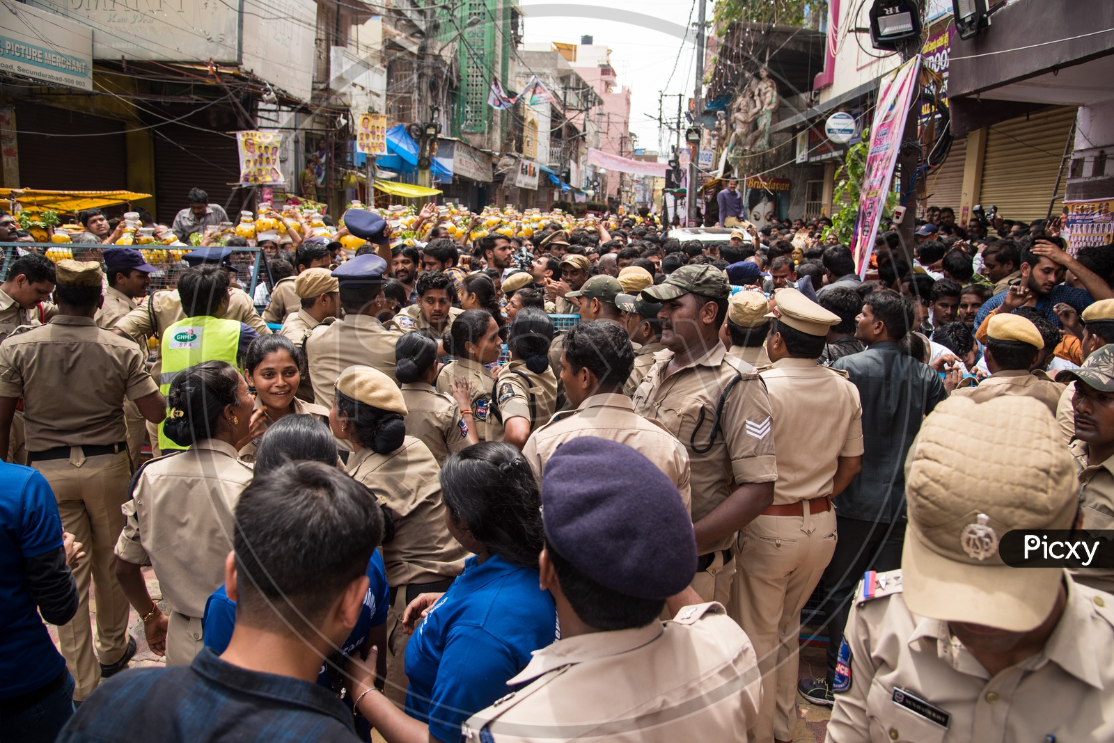 Police controlling the crowd visiting Mahankali Bonalu at Secunderabad