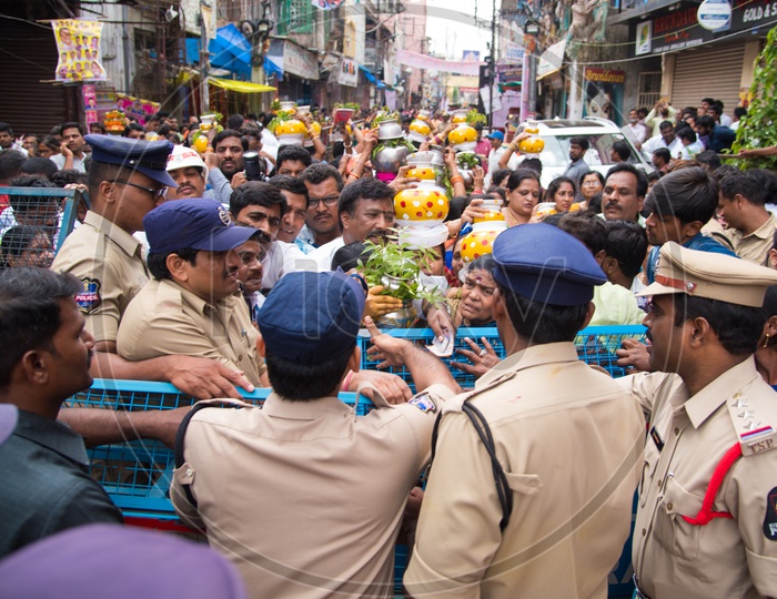 Police controls crowd during Bonalu at Mahakali Temple