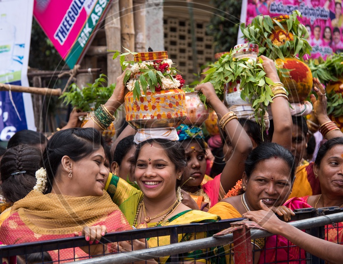 Woman carrying the Bonam pot for Bonalu Festival at Mahankali Temple