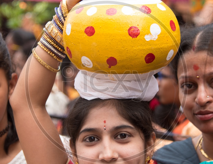Woman carrying Bonam pot as offerings to Goddess Mahankali during Bonalu Festival