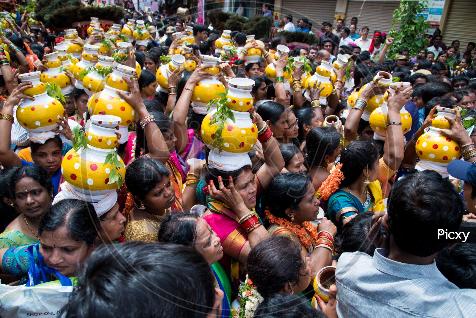 Women carrying Bonam pot as offerings to Goddess Mahankali during Bonalu Festival