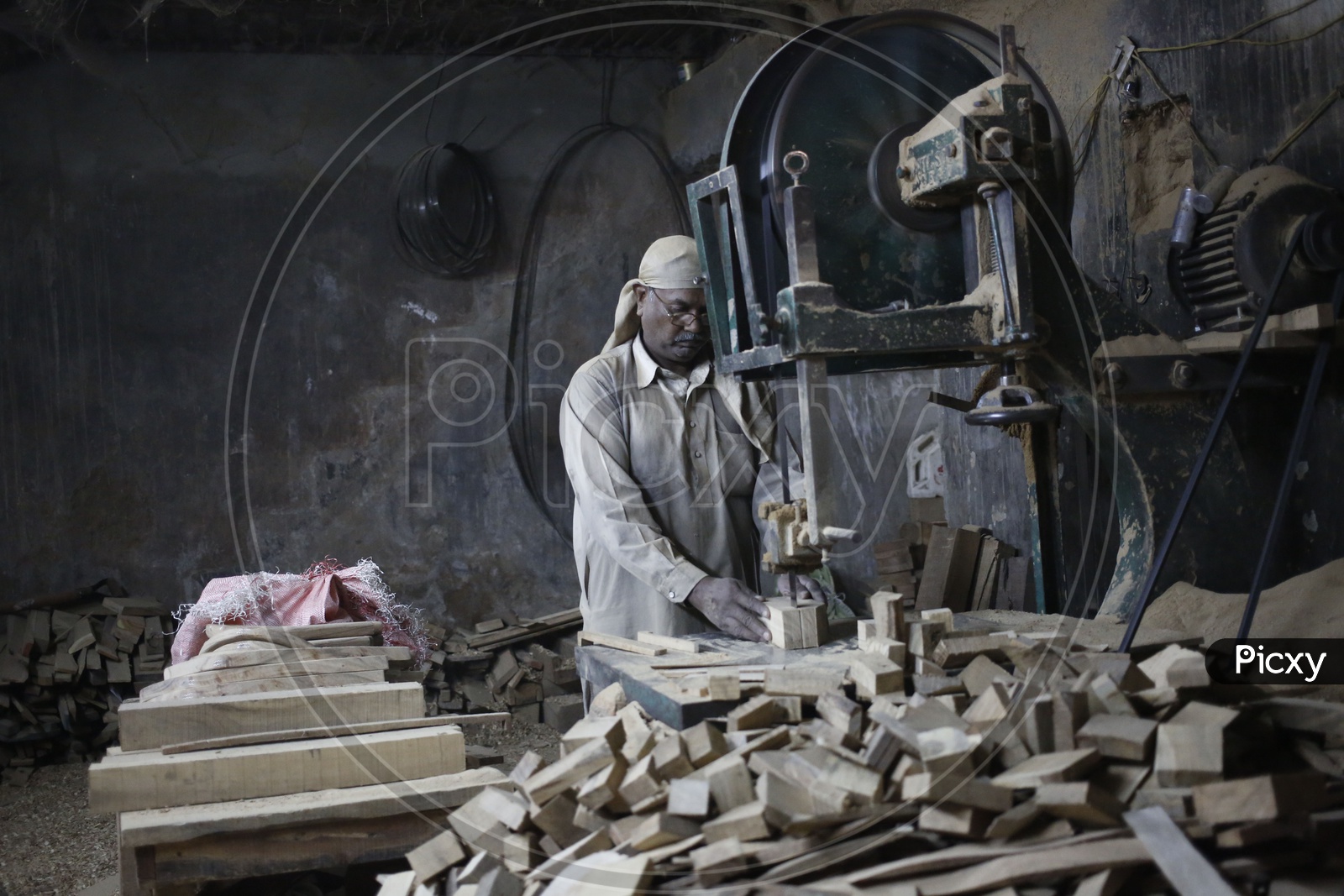 Worker cutting Wood using Machine
