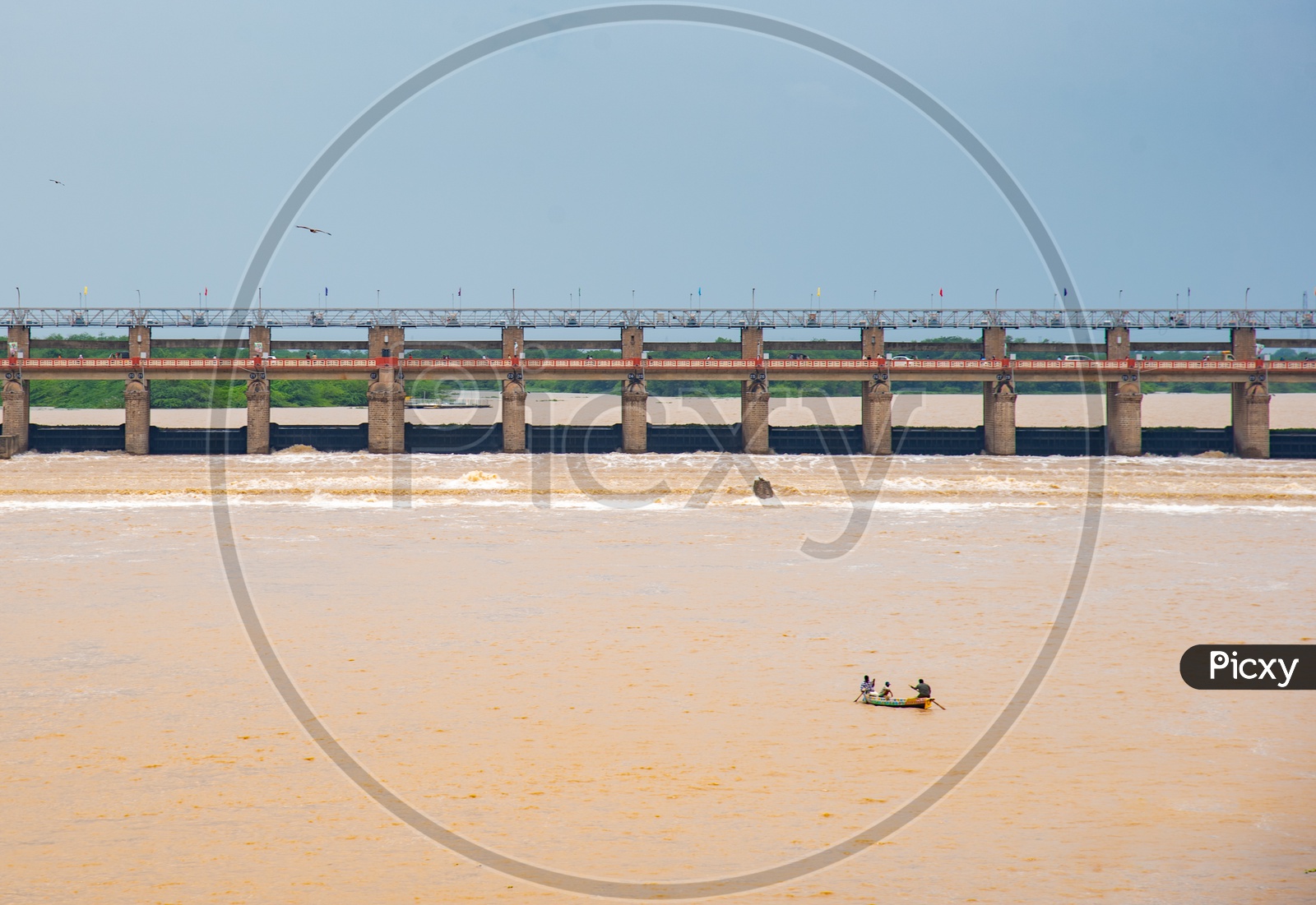 Fishermen Fishing on boats against the Current of Water at Prakasam Barrage