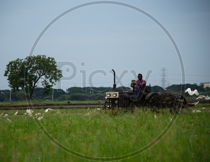 farmer ploughs with a tractor