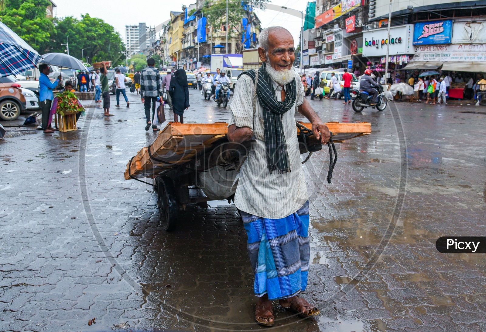 An old man with amputated arm tranporting heavy goods