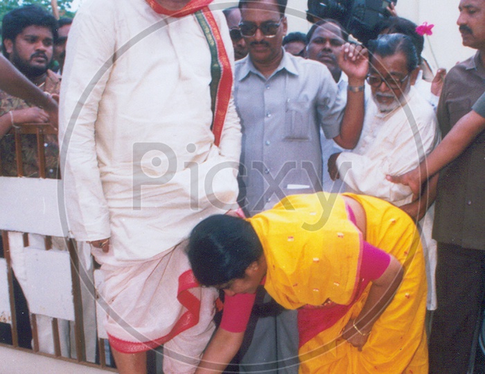 N T Rama Rao ( NTR)'s feet being cleaned by his wife Lakshmi Parvati.