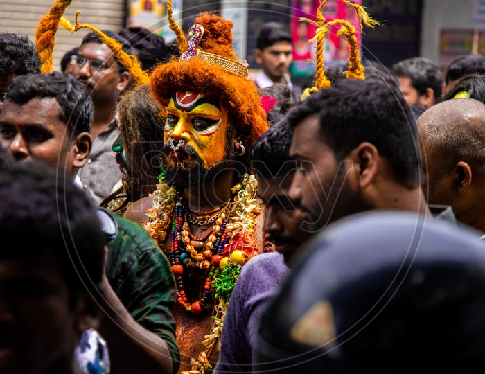 Pothuraju  Being Beating  and Dancing along The Crowd With  Red Coloured Lashing  Whips And With Neem  Leafs  at Bonalu Festival