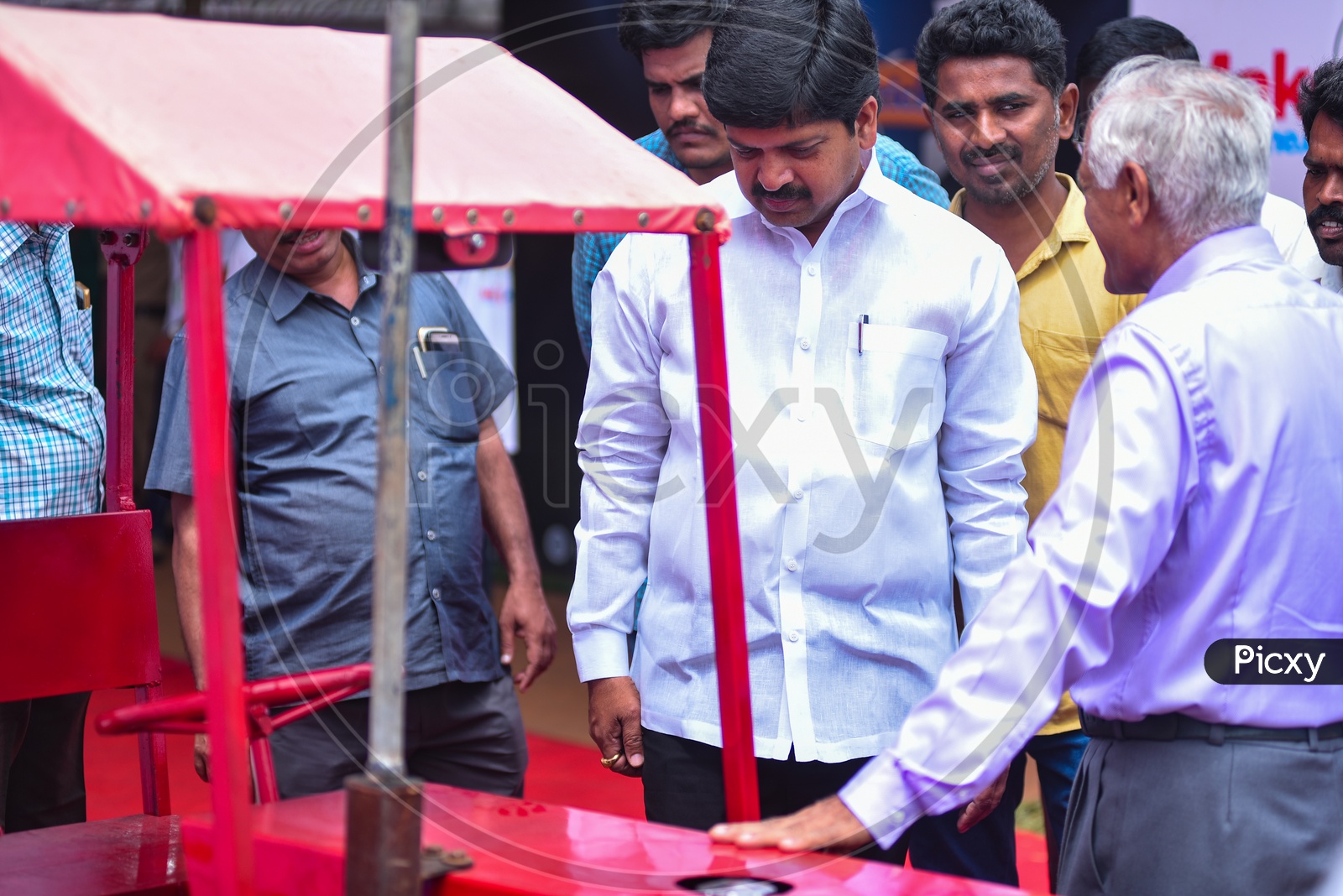 Kollu Ravindra examining A MINI tractor,Amaravati Makers Faire,2018
