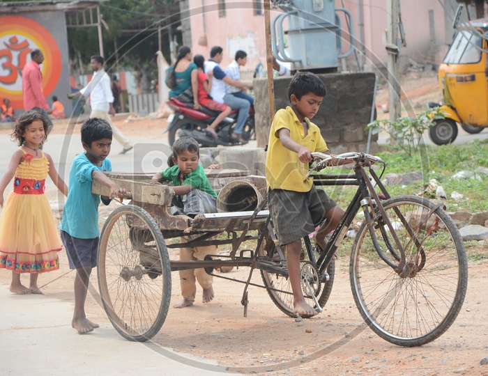 Kids on Street pulling a Rickshaw