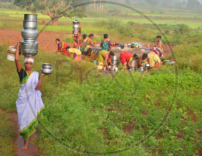 Tribal Women carry Water on their head.