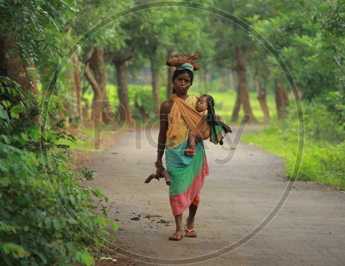 Tribal Woman carrying her child