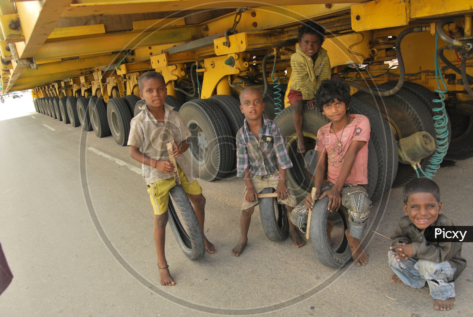 Group of Children under a Heavy Vehicle