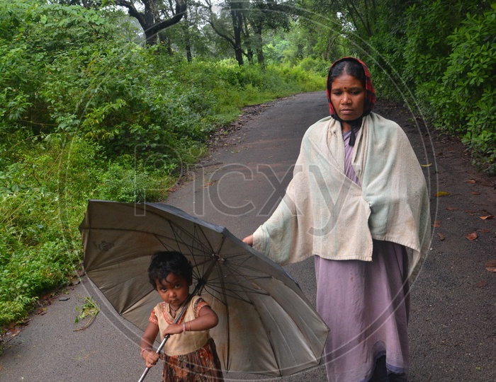 Tribal Woman with Child walking on road