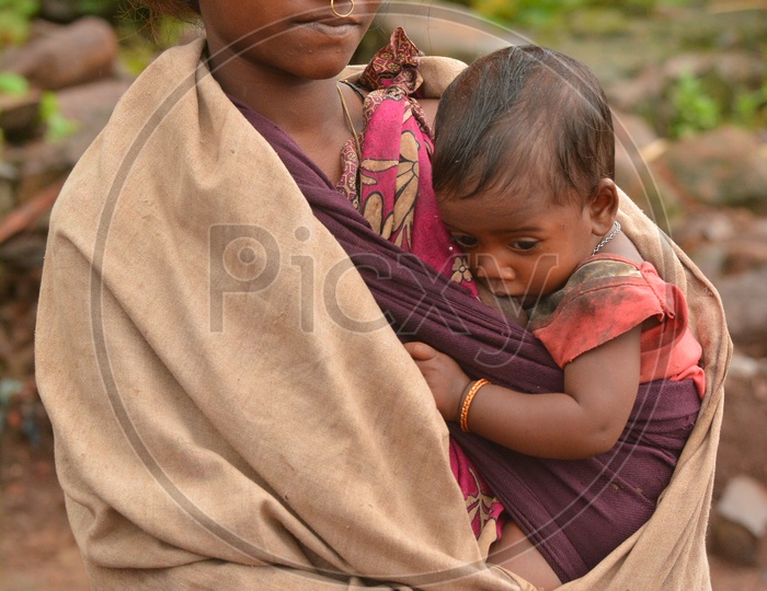 Tribal Woman breast feeding her child