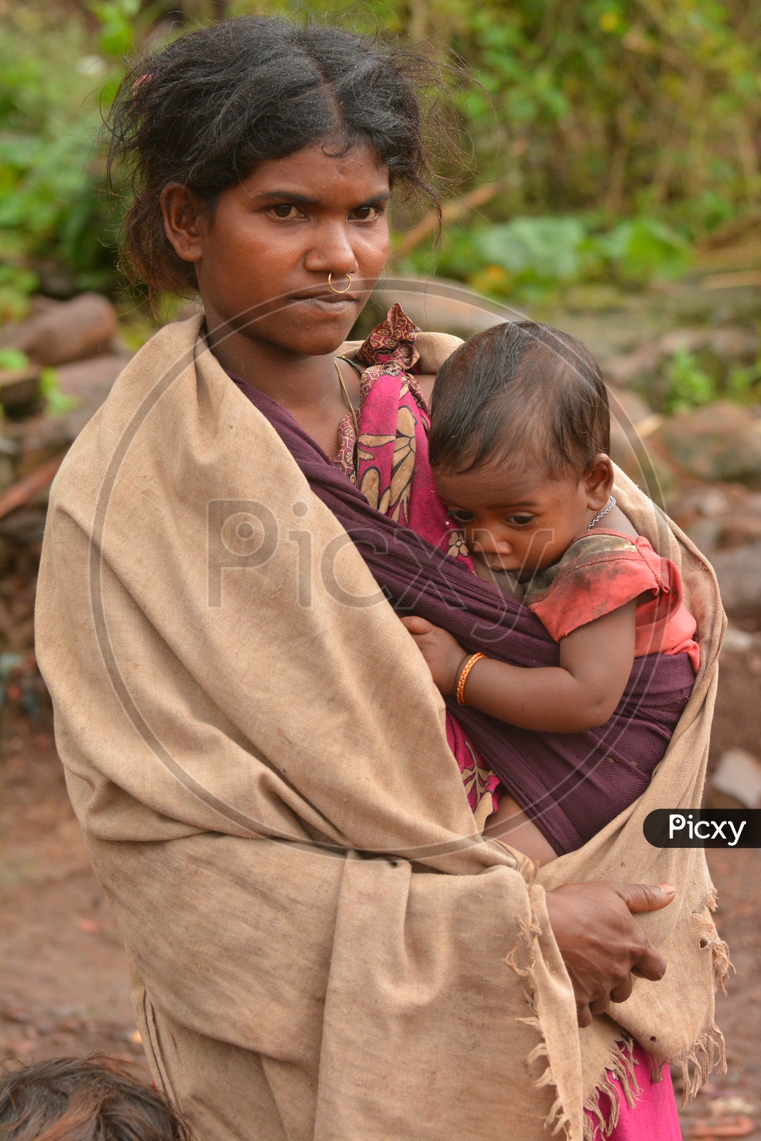 Tribal Woman breast feeding her child