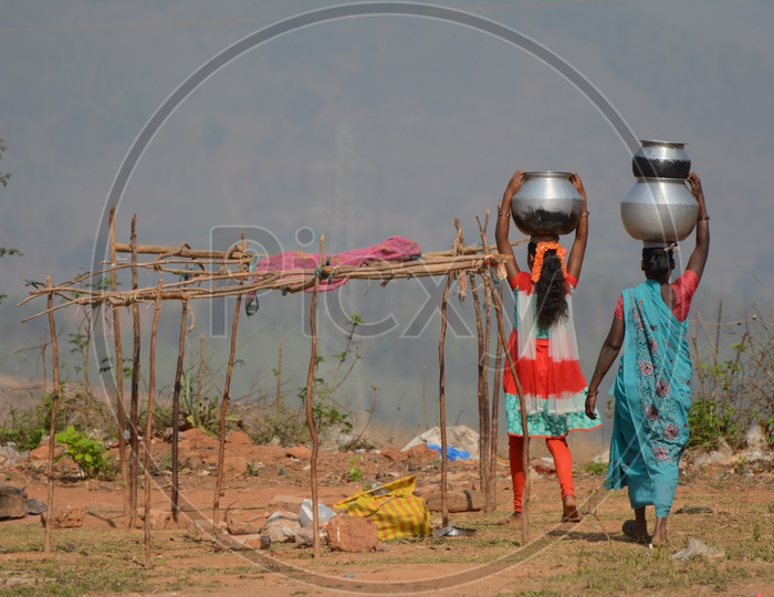 Tribal Women Carrying water on their Head