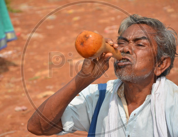 Old man Drinking Palm Wine