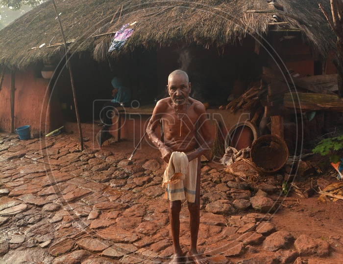 Araku Tribal Old man bathing outside House