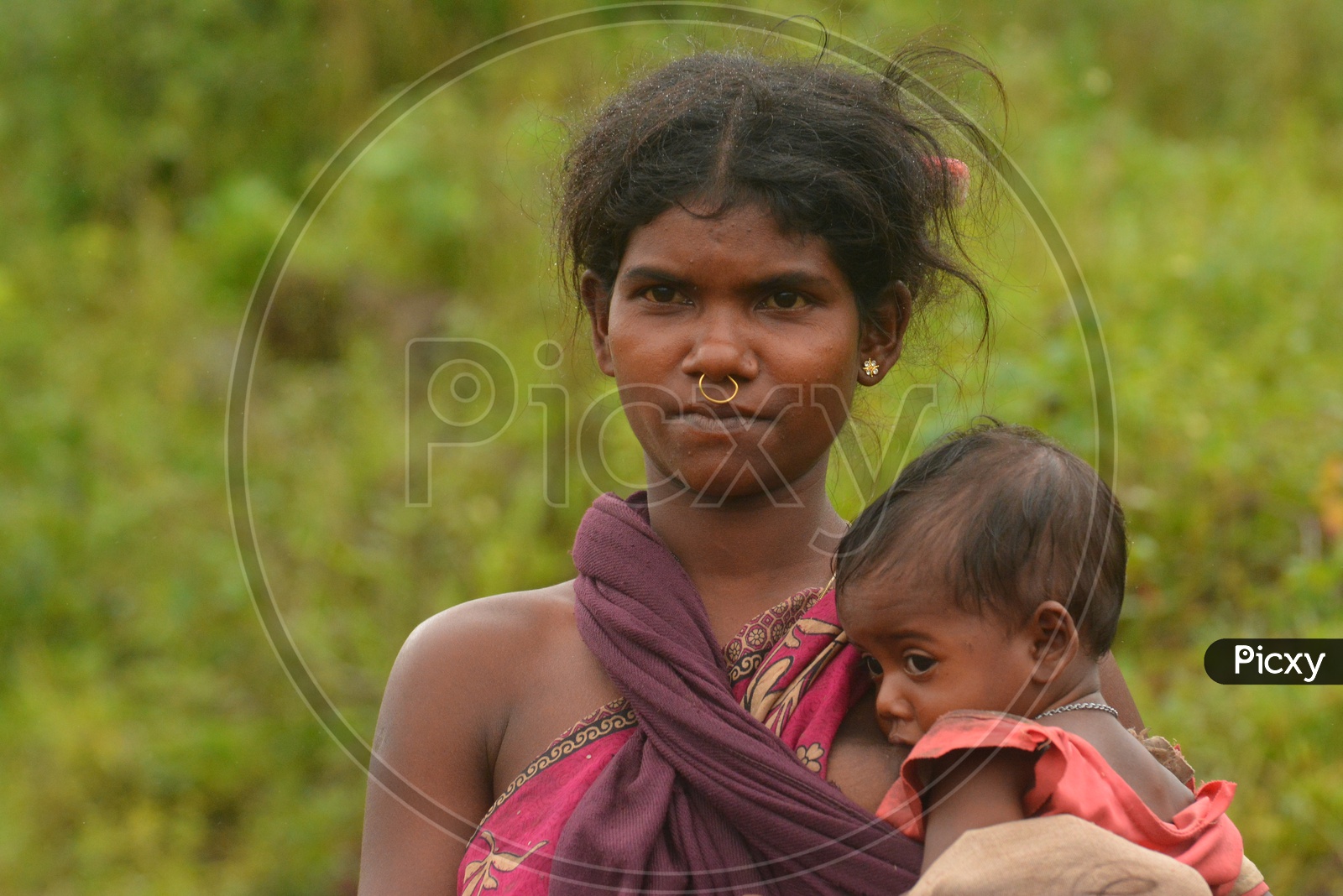 Tribal Woman Breast Feeding her Child