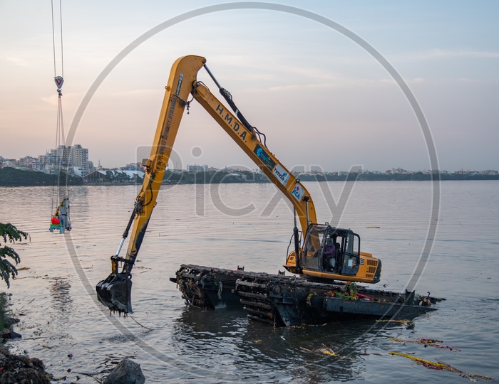 Hyderabad Muncipal Development Authority HMA Machineries cleaning/removing the Ganesh Idols immersed during Ganesh Nimarjanam