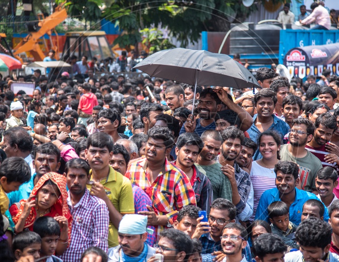 Devotees take cover from sun during the Khairatabad Ganesh Procession on NTR marg
